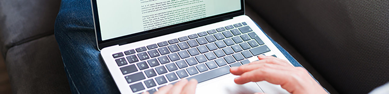 Hands typing on laptop